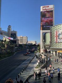 people are walking around in front of the las vegas hotel and casino on a sunny day