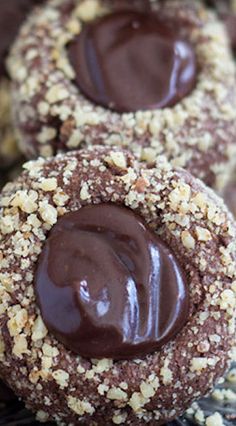 chocolate covered cookies sitting on top of a cooling rack