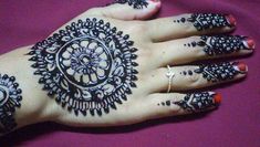 a woman's hand with henna tattoos on it