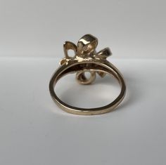 This is a fun floral pearl ring crafted in the Mid-Century era. The ribbon like petals form a large floral bow with has great finger coverage. This is a sweet feminine look. 14K Yellow Gold Weight: 4.59g size 6 (sizable upon request) People have coveted natural pearls as symbols of wealth and status for thousands of years. A Chinese historian recorded the oldest written mention of natural pearls in 2206 BC. As the centuries progressed toward modern times, desire for natural pearls remained stron Unique White Gold Flower Ring For Wedding, Formal Hallmarked Flower Ring, Unique Hallmarked Flower Ring For Wedding, Heirloom Flower Rings For Formal Occasions, Formal Heirloom Flower Rings, Vintage Formal Rings With Flower Shape, Unique Yellow Gold Flower Ring For Wedding, Unique Yellow Gold Wedding Flower Ring, Unique Wedding Rings With Flower Shape