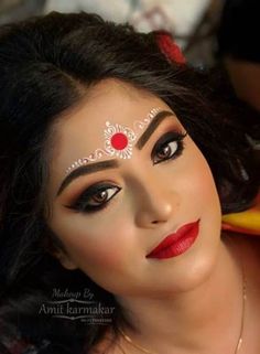 a woman with makeup on her face and red lipstick