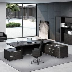 an office with black furniture and large windows