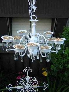 a white chandelier hanging from the side of a building