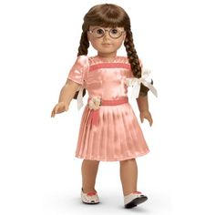 an american girl doll wearing glasses and a pink dress