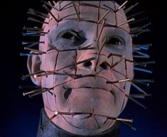 a creepy man with barbed wire on his face