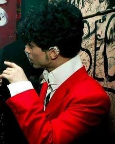 a man in a red suit and white shirt