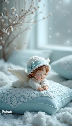 a little angel sitting on top of a pillow