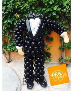 a statue of a man in a tuxedo suit