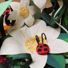 paper flowers with ladybugs and leaves on them