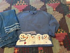 I have sewn a Winter Appliqued Sweatshirt of 5 Snowmen on a Blue Sweatshirt.   I have embroidered  Snow Swirling By.  With the use of Warm and Natural my snowmen have a fuzzy look. I have cropped my sweatshirt to present a casual look.   By using a Unisex size my sweatshirts are roomy and comfortable. I have been sewing sweatshirts for 20 years.  In the beginning I gave all of my sweatshirts to friends and family.  Approximately 15 years ago my friends and family suggested that I attempt to sell my sweatshirts instead of just giving them away.  I started by going to the Quad-City Arts and Craft Sale at EXPO Center in Rock Island, Illinois.  I have done very well at the show, and I have developed a following of repeat customers that always come to my booth to see what is new each year.  Bec Casual Winter Sweatshirt With Machine Embroidery, Casual Winter Tops With Machine Embroidery, Casual Machine Embroidered Tops For Winter, Long Sleeve Tops With Machine Embroidery For Winter, Casual Winter Hoodie With Machine Embroidery, Blue Embroidered Tops For Winter, Blue Tops With Embroidered Graphics For Winter, Winter Blue Tops With Embroidered Graphics, Winter Sweatshirt With Appliqué Logo And Long Sleeves