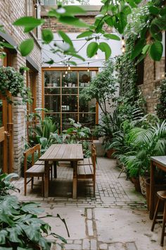 an outdoor dining area with tables, chairs and potted plants