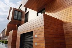 a building that is made out of wood and has garage doors on the side of it