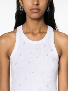 Imagine a tank top that's as comfy as your favorite tee but with a sprinkle of glamour. This top effortlessly combines cool, casual vibes with a touch of sparkle from its rhinestone logo. Perfect for pairing with your go-to jeans or that chic skirt you love. White cotton with ribbed detailing All-over rhinestone logo-lettering Round neck and sleeveless design Straight hem for a clean look Composition: 100% cotton Made in Portugal Season: FW24 | The Attico Women's Allover Logo Cotton Tank Top in Chic Skirts, The Attico, Italian Fashion Designers, Cotton Tank Top, White Crop Top, White Tank Top, Woman Colour, Primavera Estate, Italian Fashion