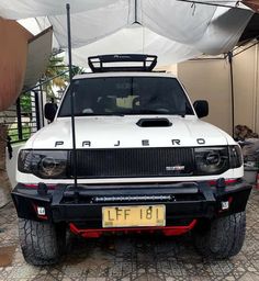 a white pick up truck parked under a tent