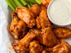 chicken wings, celery sticks and carrots with ranch dressing on the side