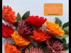 felt chrysanthemum flowers in red, orange and yellow colors with green leaves