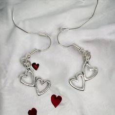 Our enchanting double heart Earrings - a whimsical blend of elegance and charm designed for special occasions such as birthdays, Valentine's Day, Mother's Day, or any moment you want to make unforgettable. Crafted with meticulous attention to detail, these earrings are designed to captivate with 2 hollow hearts pendant suspended from French wire hooks. The hooks, plated with 14k white gold, ensure both style and hypoallergenic comfort for all-day wear. The double heart pendant, made from silver- Heart Charm Dangle Jewelry For Gifts, Heart Charm Dangle Jewelry For Anniversary, Anniversary Heart Charm Dangle Jewelry, Anniversary Dangle Jewelry With Heart Charm, Hypoallergenic Drop Earrings For Valentine's Day, Mother's Day Metal Jewelry With Matching Earrings, Mother's Day Heart Drop Earrings, Heart Shaped Metal Earrings For Valentine's Day, Heart-shaped Metal Earrings For Valentine's Day