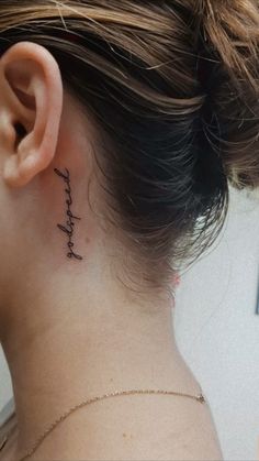 a woman with a small tattoo on her neck that says, i love you in cursive writing