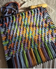 an assortment of crochet hooks and yarns laid out on a bed