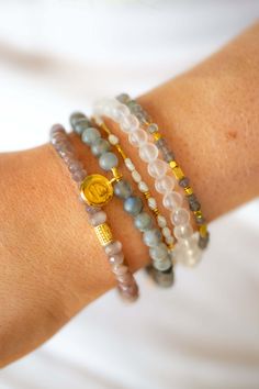 The bigger Labradorite bead in the Mana bracelet adds dimension and depth and is designed to bring out the colors in your outfit or enhance the look of your layered bracelets. The bright gold findings add a pop of color, elevating the natural blue, green and grey colors. A romantic piece that pairs well with any neutral color. Gold Bracelets With Round Beads For Layering, Modern Beaded Bracelets With Natural Stones, Adjustable Faceted Beads Bracelets For Layering, Layering Gold Beaded Bracelets With Faceted Beads, Spiritual Gold Wrap Bracelet With Round Beads, Everyday Beaded Bracelets With Gemstone, Bohemian Bracelets With Faceted Beads For Everyday, Bohemian Faceted Beads Bracelets For Everyday, Bohemian Bracelets With Spacer Beads For Everyday