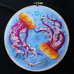 an embroidery project with two jellyfishs in the water