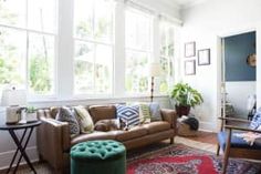 a living room filled with furniture and lots of windows