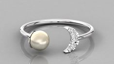 14K solid gold ring with an open top design with one pearl on one side and a diamond moon on the other side. A lovely one-of-a-kind design perfect for any occasion. Features * Gold KT: 14K * Diamond Cut: Round * Setting Type: Prong Set * Number of Stones: Five * Total Diamond Weight: 0.05 tcw * Diamond Color Clarity: G-H color SI-VS Clarity If you want this ring with color gemstones, please send us a message, and we will quote you a price with your desired stones. Return policy: Sizes below 5 an Elegant White Crescent Rings, Elegant White Gold Rings With Moon Phase Detail, Elegant Open Ring With Moon Phase Design, Elegant Open Ring Jewelry With Moon Phase Detail, Elegant Open Ring With Moon Phase, Elegant Open Ring Jewelry With Moon Phase, Baguette Cut Ring, Peacock Ring, Ring Moon