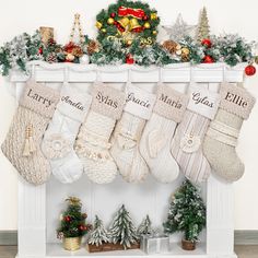 stockings hung on the mantle with christmas decorations