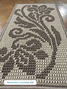 a crocheted rug with an image of a man's face on it