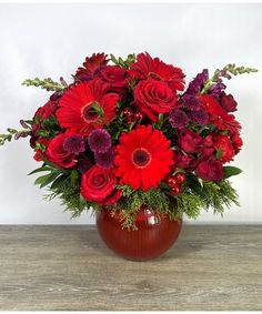 Cozy up under the blankets and bring the holidays home with Cinnamon Cider, our elegant and impactful all red design for the season. Arranged in our ribbed glass bowl you will find red roses, red gerbera daisies, mums, snaps, tree balls, evergreen, and more for a truly stunning design perfect for a centerpiece, for the foyer, or even the kitchen island. Truly, this design would look gorgeous wherever you place it! Poinsettia Care, Red Gerbera, Home Flower Arrangements, Get Well Flowers, Champagne Gift, Gerbera Daisies, Roanoke Va, Roses Red, Table Centrepiece