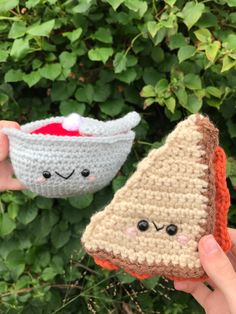 two crocheted pieces of bread with faces on them are being held by someone's hand