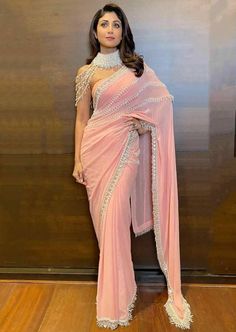 This Mala Sari is pure georgette peach sari embellished with tasseled pearls all over the hem and pallu of the sari. Tube ruched blouse, paired with a pearl collar with tassels and strings to go around shoulder and arms. A showstopper sari for sure! Isha Ambani, Starry Wedding, Gauri Khan, Ruched Blouse, Karisma Kapoor, Pearl Collar, Indian Fashion Saree, Kareena Kapoor Khan, Bridal Dress Design