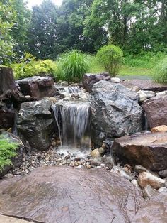 a small waterfall in the middle of some rocks