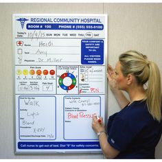 a woman writing on a hospital bulletin board