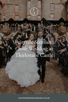 a bride and groom walking through confetti in front of their wedding party at thriftestane castle