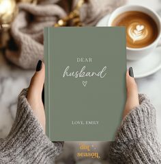 a person holding a book with the title dear husband love, family written on it