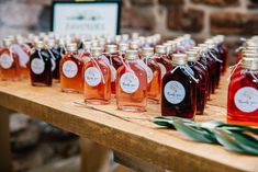 many bottles of liquid are lined up on a table