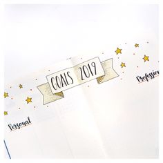 an open planner book with the words goals written on it and stars around the pages