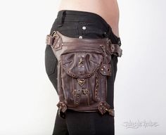 Capable of multiple ways to wear, our innovative designs include a strap that allows the bag to configure into a Hip Bag, Waist Bag, Thigh Holster, Fanny Pack, Shoulder Bag, Everyday Purse, Messenger Bag, BackPack, Thigh Bag, Under Arm Holster and Shoulder Holster. ONE BAG - MANY DIFFERENT WAYS TO ROCK IT: 1. Around your waist like a holster bag. 2. Undo the straps and it can be also transformed into a bag worn like a shoulder holster bag. (secured in place with extra back piece included, see ph Steampunk Leather Bag With Belt Loops, Steampunk Leather Bags With Hardware, Thigh Holster, Thigh Bag, Holster Bag, Everyday Purse, Utility Bag, Go Bags, Biker Chick