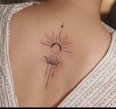 a woman with a tattoo on her shoulder and the sun in the sky behind it