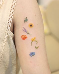 a woman's arm with flowers painted on it