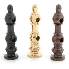 three different types of wooden candlesticks in gold, black and silver colors on a white background