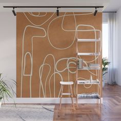 an abstract painting on a wall in a room with wooden flooring and ladders