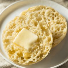 two pieces of bread on a plate with butter