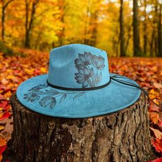 Wide Brim Hat in a Peacock Blue. This Hat is Burned using Pyrography Techniques. Each Hat burned is drawn freehand therefore each one is a ONE of a KIND. Hats are all sprayed for weather and wear. Each Hat comes with a handcrafted Macrame Wall Hanger & a Signature Dust/Travel Bag. Turquoise Fedora Hat For Spring, Blue Hats For Outdoor Fall Activities, Turquoise Fedora For Spring, Artistic Short Brim Hat For Spring, Turquoise Hat With Curved Brim, Blue Bohemian Cap Hat, Artistic Adjustable Blue Hat, Pyrography Techniques, Macrame Wall Hanger