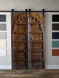 two wooden doors are open in front of some color swatches