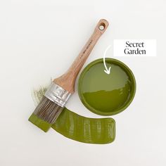 a paint brush and green powder on a white surface with the words secret garden above it