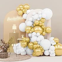 gold and white balloons are arranged in the shape of an eiffel tower on a table