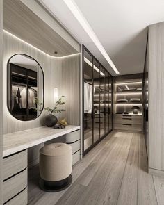 a walk - in closet with dressing area and mirror on the wall next to it