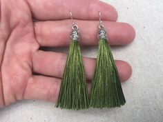 "Chic olive green tassel earrings! They would add a pop of color to any outfit for any occasion. Dress them up or down. They are timeless and versatile. They are lightweight, fun and unique! The tassels measure 2 1/8\" long by 1/4\" wide. They hang from simple silver ear wire hooks. Overall drop length is about 2 1/4\". Metal is allergy free plated silver. These are my latest creation! I have them available in many colors! Find them all under the category tassel earrings in my shop. Thanks for s Green Tassel Drop Earrings, Green Tassel Dangle Earrings, Green Beaded Tassel Drop Earrings, Green Tassel Earrings For Gift, Green Tassel Drop Earrings As Gift, Green Tasseled Jewelry For Gifts, Olive Green Jewelry, Green Tassel Earrings, Crescent Moon Jewelry